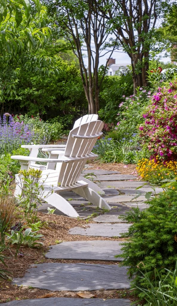 A well maintained garden with trimmed grass and greenery representing professional outdoor services by Ridge