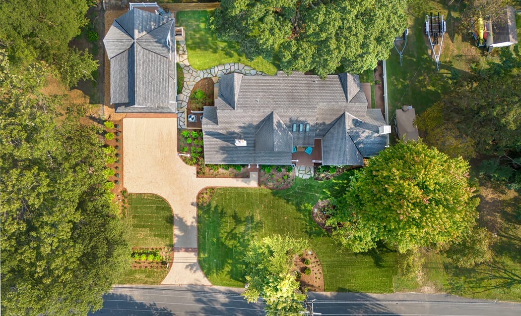 Residential exterior with trimmed hedges and a tidy front landscape layout.