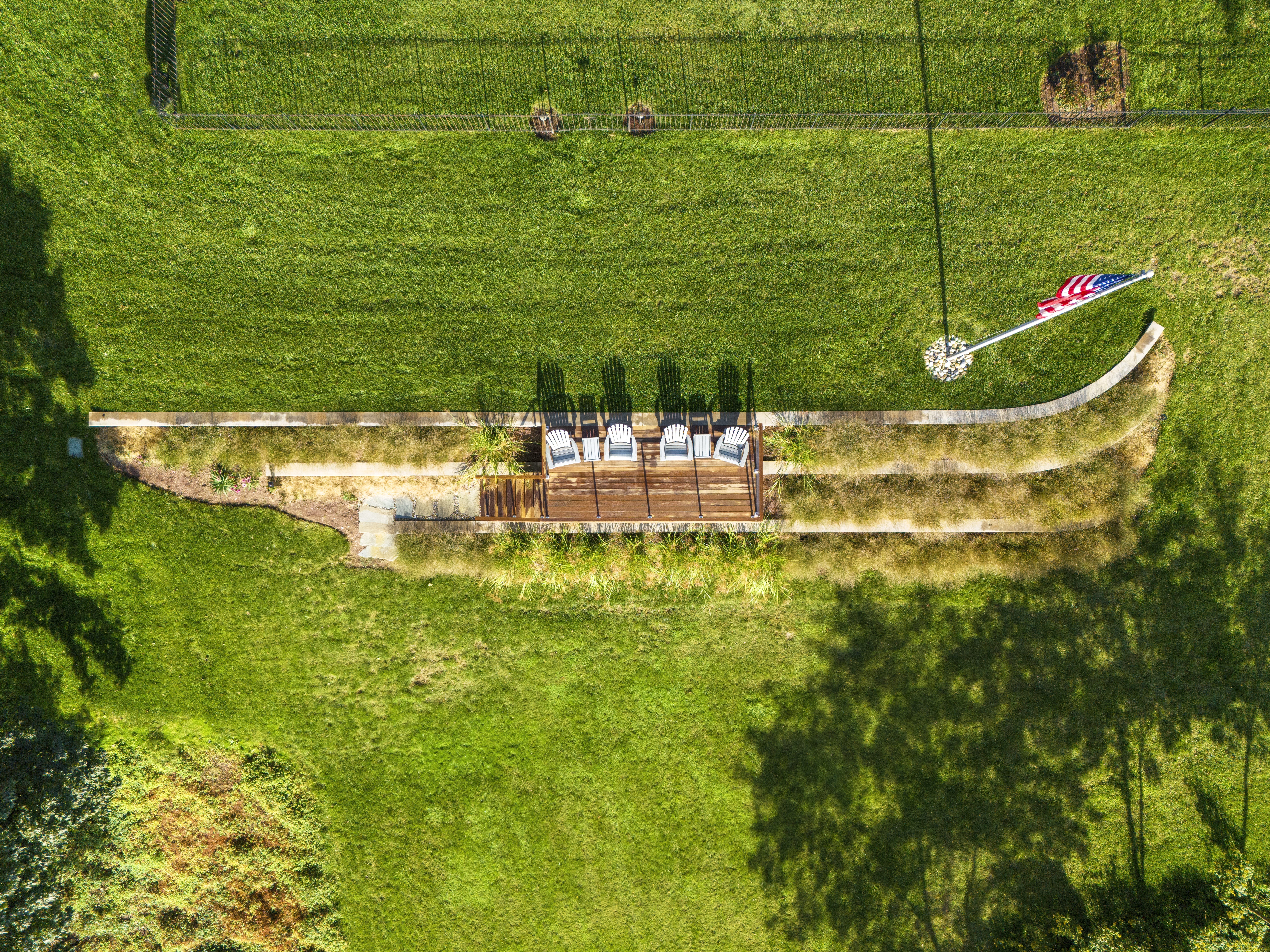 Tiered stone retaining walls with landscaping and outdoor seating area - Ridge