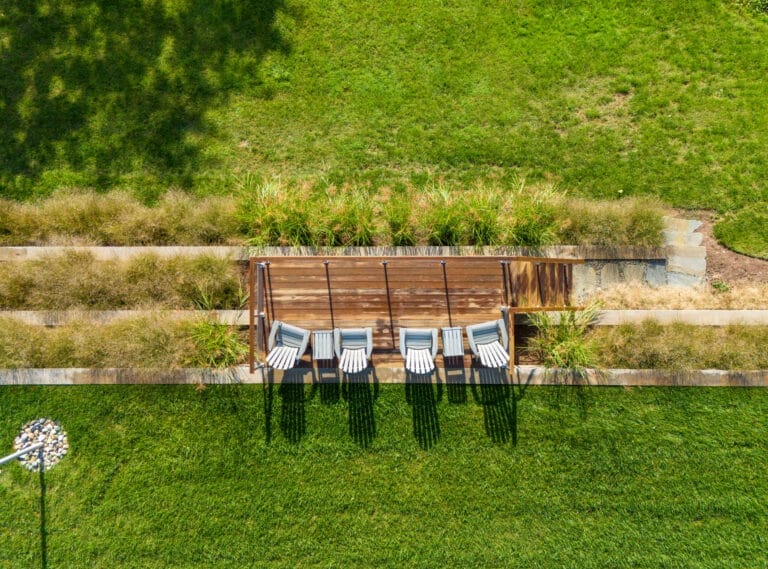 Curved paver walkway with landscaped garden beds and lawn - Ridge