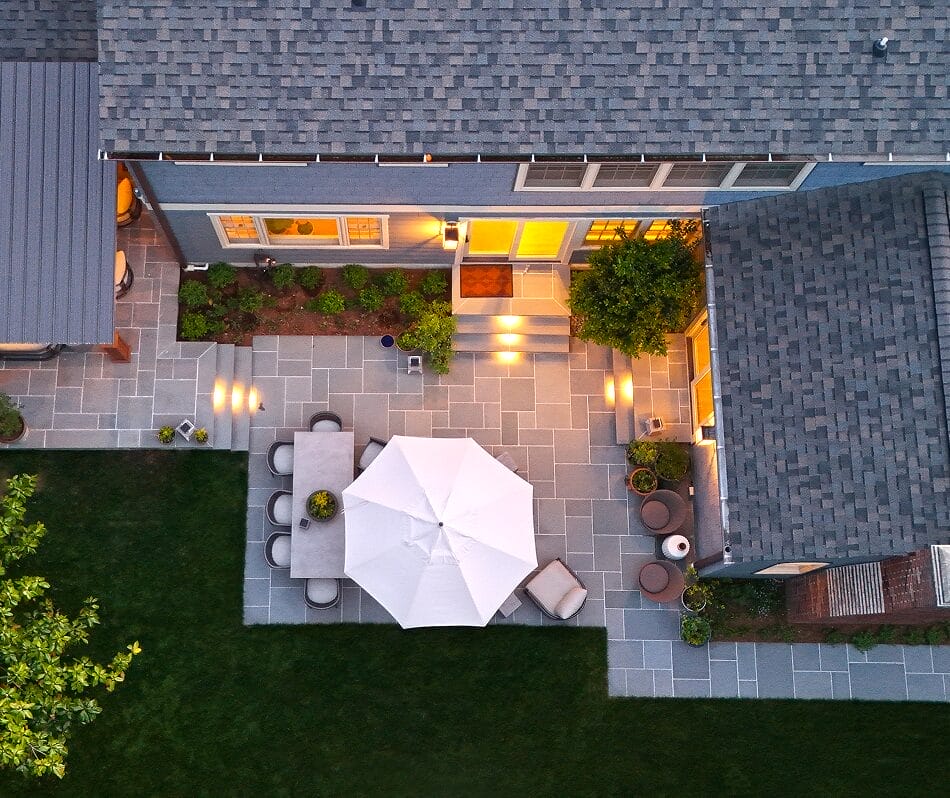 Modern home aerial view with landscaped yard patios walkways and lush greenery around house by Ridge