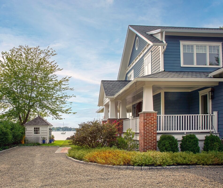 Front-yard landscape with well-shaped shrubs and a maintained entryway to the home.