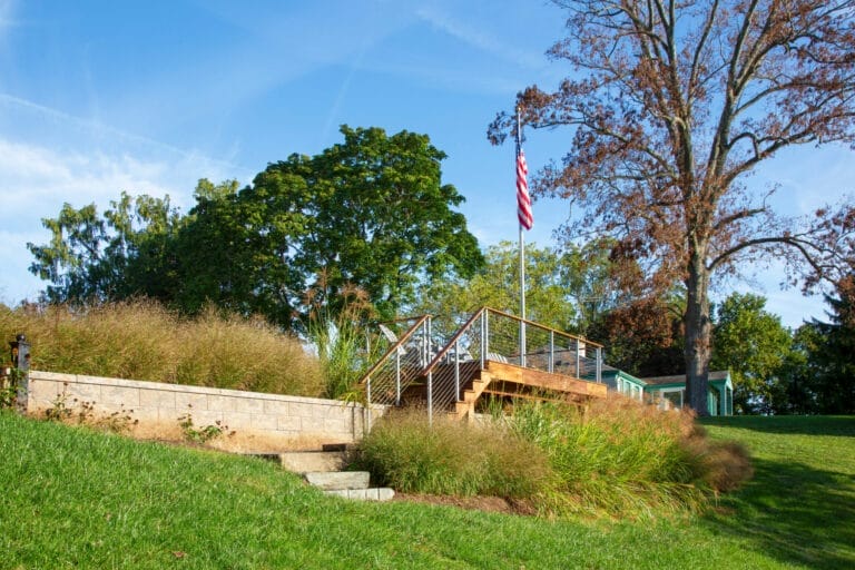 Stone retaining wall built for both support and curb appeal in a landscaped property.